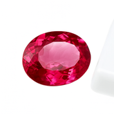 A stunning 26.25-carat natural bi-color oval-cut sapphire, displaying a beautiful transition of colors.