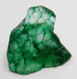 “Natural green mineral specimen with visible fractures and organic texture.”