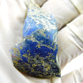 Certified Lapis Lazuli Rough 110.50 Carat Natural Blue Uncut Raw Gemstone held in hand
