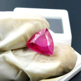 Pink ruby 6.90 carat placed on glowing surface, highlighting vibrant pink color