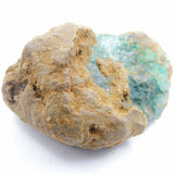 Mineral sample with a clear crystal inside on a white background