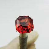 Square-cut orange sapphire, 10.52 carats, a certified natural gemstone.