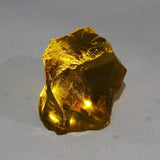 Brazilian Yellow Rough Lemon Topaz held in hand product shot