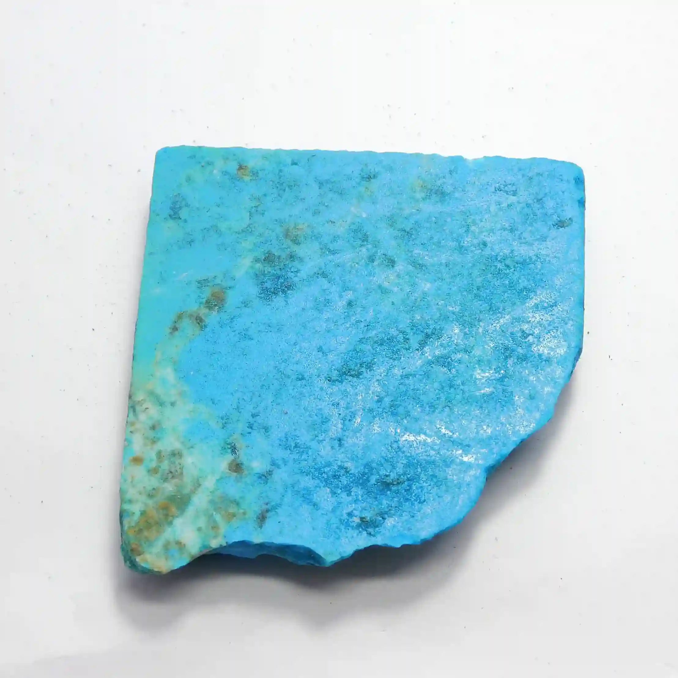 “Flat slab of natural turquoise stone with blue and green matrix patterns on a white background.”