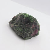Raw green and pink stone on a white background