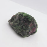Raw green and pink stone on a white background
