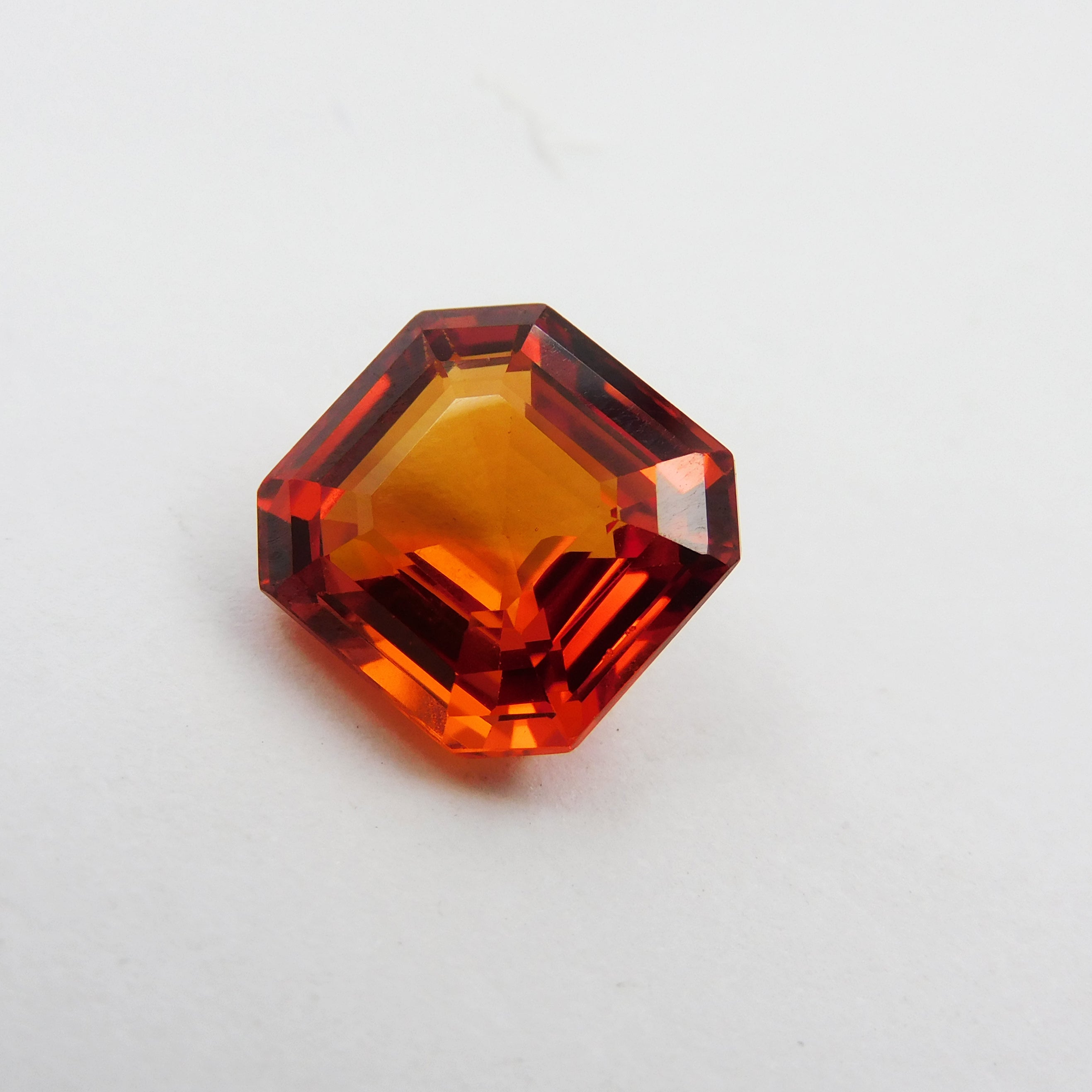 Certified 6.35ct square-cut orange sapphire.