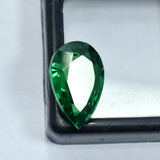 Pear Cut Brazilian Green Garnet facing downward on black box with transparent center – 10.65 Carat