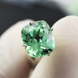 Natural 9.00 carat cushion-cut bluish-green sapphire.