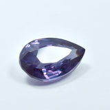 Color change Alexandrite gemstone displayed on clean white background showing pear cut
