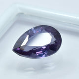 Certified pear-shaped Alexandrite placed on white-bordered box with clear center for jewelry display