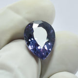 Pear Cut Alexandrite 5.30 Ct Held in Gloved Fingers – Natural Color-Change Gemstone