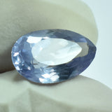 4.05 Ct Alexandrite Pear Cut Gemstone Held Between Two Fingers – Certified Natural Color-Change Gem