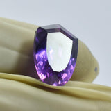 10.80 Ct Purple Tanzanite Fancy Cut Gemstone Held Between Fingers - Certified Loose Stone