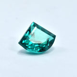 Fancy cut 10.70 Ct Green Garnet placed upside down on a plain white background, translucent loose gemstone