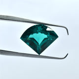 Jewel tool holding 10.70 Ct Fancy Cut Green Garnet upright, natural and clarity-enhanced gemstone