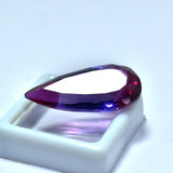Certified 30.60ct natural bi-color sapphire, a pear-cut loose gemstone.