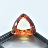 Certified 15.90ct natural bi-color sapphire, trillion cut, on best offer.