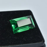 Emerald-cut tsavorite garnet featured on a clean black box base, its deep green hue standing out with elegant contrast