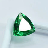 Triangular green gemstone on a white background