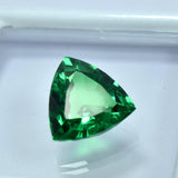 Certified Trillion Cut Green Tsavorite Garnet 10.65 Ct placed at the center of a white-bordered box with transparent sheet