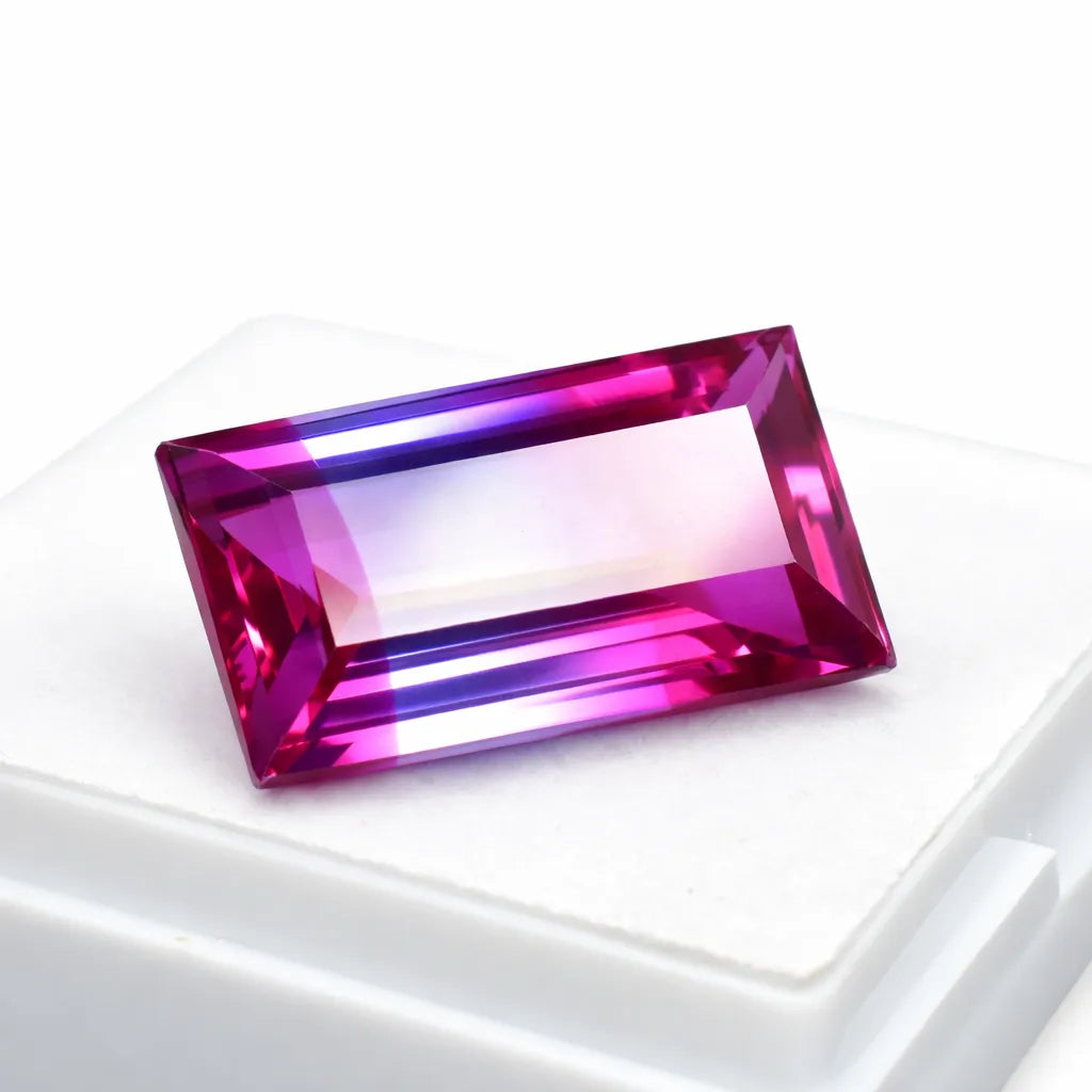 Rectangular pink and purple gemstone on a white background
