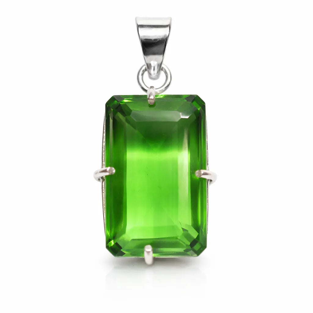 Green gemstone pendant with silver setting on a white background