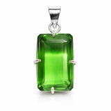 Green gemstone pendant with silver setting on a white background