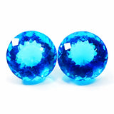 Two blue gemstones on a white background