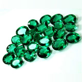 Collection of green gemstones on a white background
