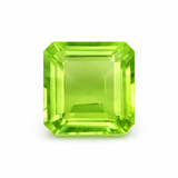 Green gemstone with an emerald cut on a white background