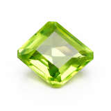 Green gemstone with a square cut on a white background