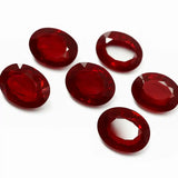 Red gemstones on a white background