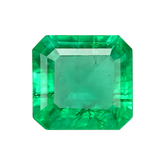 Faceted green gemstone on a white background