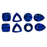 Collection of blue gemstones in various shapes on a white background