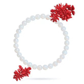 White beaded bracelet with red floral ends on a white background