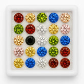 Assorted colored gemstones in a white display case