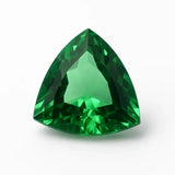 Trillion-cut green gemstone on a white background