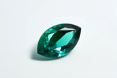 Green gemstone on a light gray background