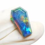 A certified, fancy multi-color opal doublet gemstone weighing 10.80 carats.