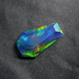 A fancy multi-color opal doublet of 10.80 carats, certified as a natural loose gemstone.