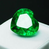 Shining Heart Cut Green Emerald 8.23 Ct in jewel display case on black background - Reflective finish
