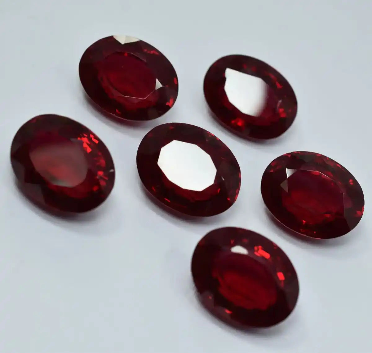 Set of red gemstones on a light gray background