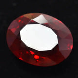 Faceted red gemstone on a black background