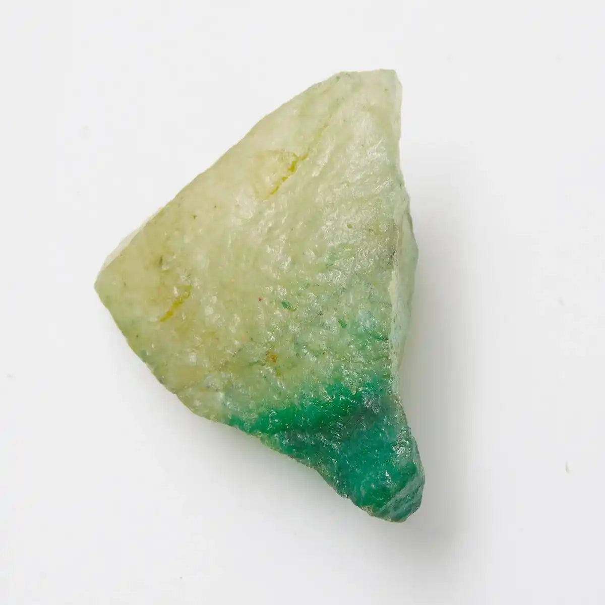 Geometric stone with green and beige colors on a white background