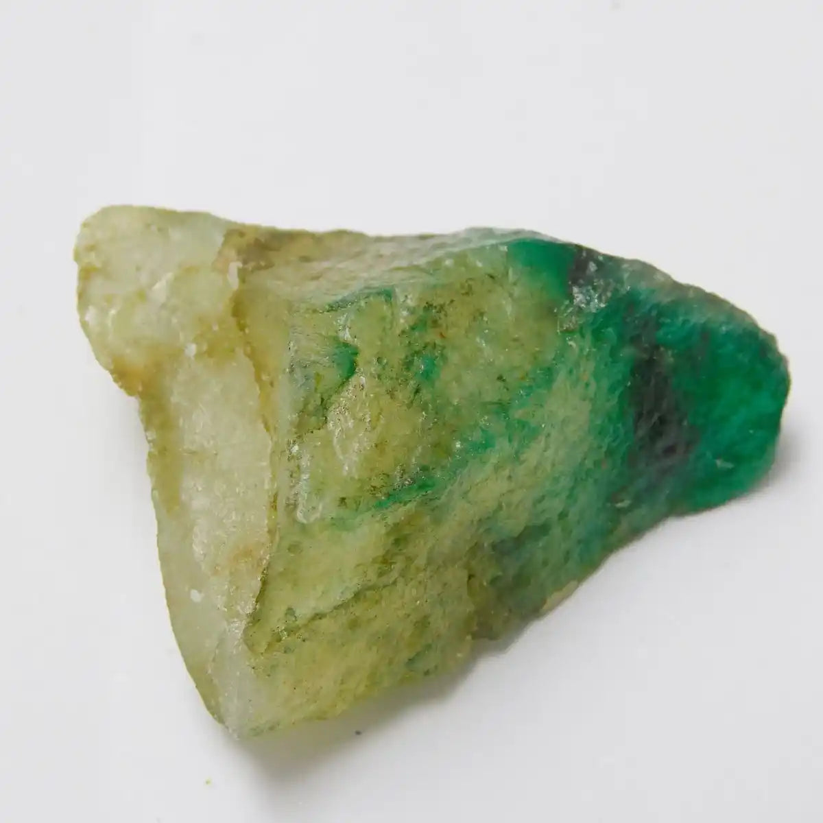 Green and white mineral specimen on a white background