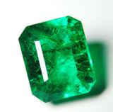 Emerald-cut Muzo Colombian emerald placed on white background