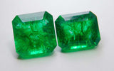A certified 18.78 Ct pair of natural square-emerald cut Colombian gemstones, showcasing matching color, fine cut grade, and clean finish on a white surface.