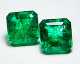  Both 9+ Ct Colombian emeralds arranged neatly on a clean white surface, highlighting their clarity-enhanced finish, balanced cut, and translucent shine.