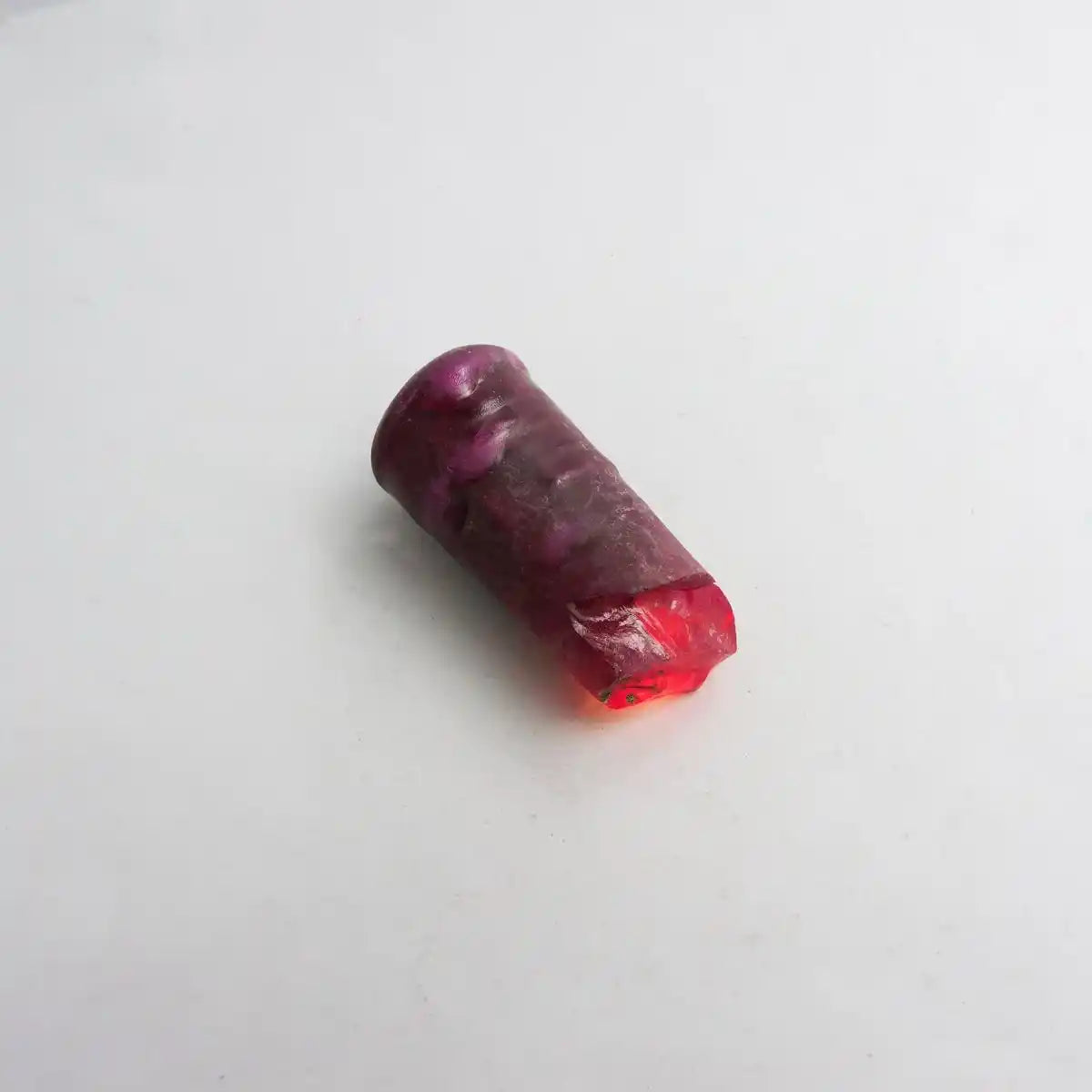 Purple and red cylindrical object on a white background